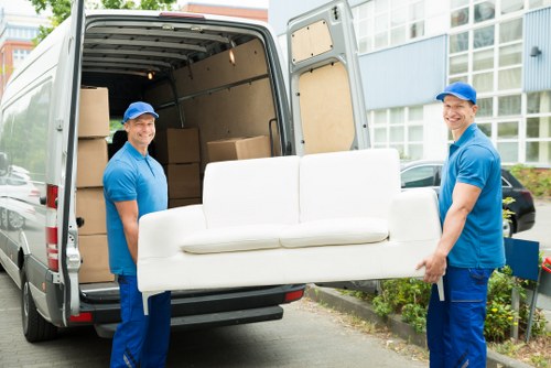 Removal van and moving team preparing a local house move in Surbiton