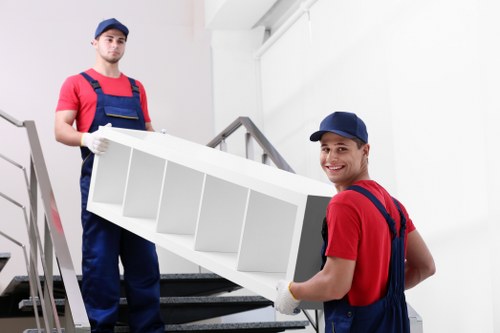 Loading furniture into a moving van in Surbiton