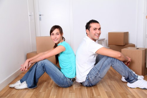 Trained removal staff carrying boxes carefully during a Surbiton van move