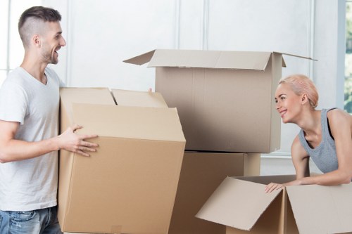 Professional movers carrying furniture from a local Surbiton home