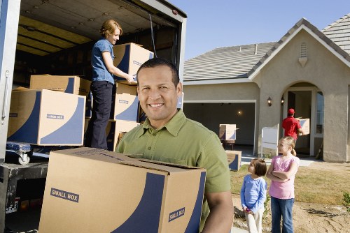 Professional movers handling furniture in Surbiton